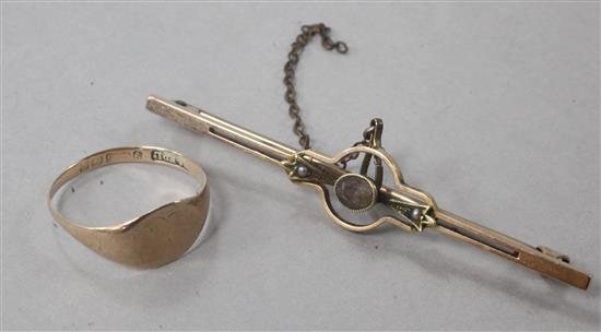 A 9ct gold ring and a yellow metal and gem set bar brooch.
